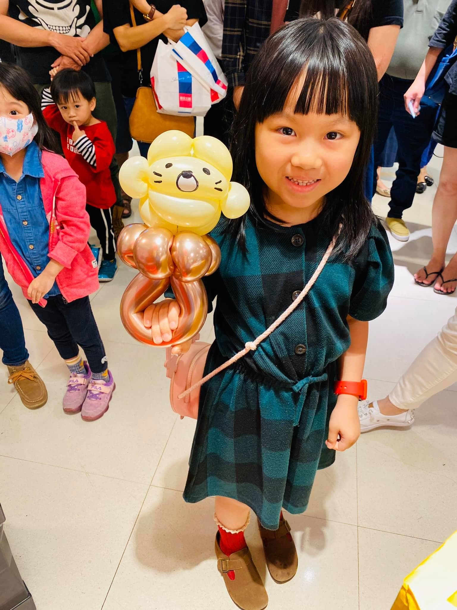 小女孩拿著白色貓咪與玫瑰金數字造型氣球