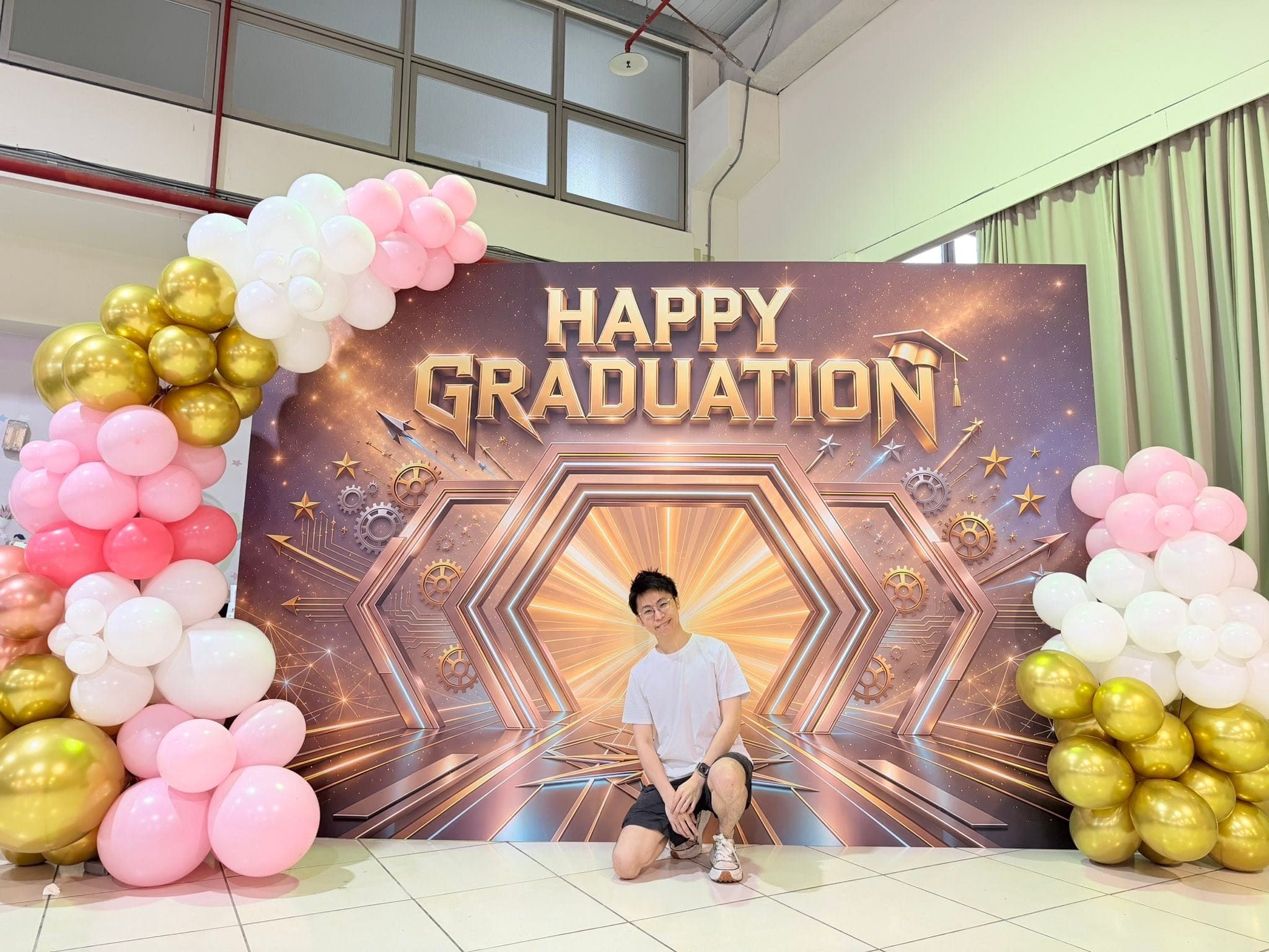 HAPPY GRADUATION 拍照背板，兩側以粉紅、白色、金色氣球堆疊裝飾