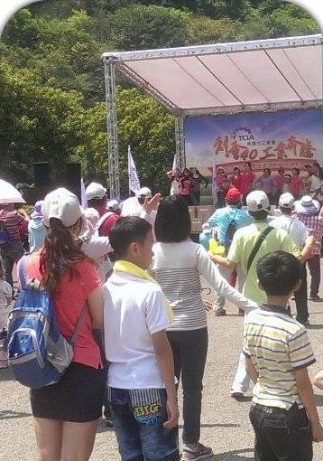 石門水庫嘉年華會舞台前，民眾與小朋友圍觀表演
