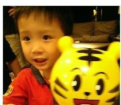 小男孩拿著黃色巧虎造型氣球