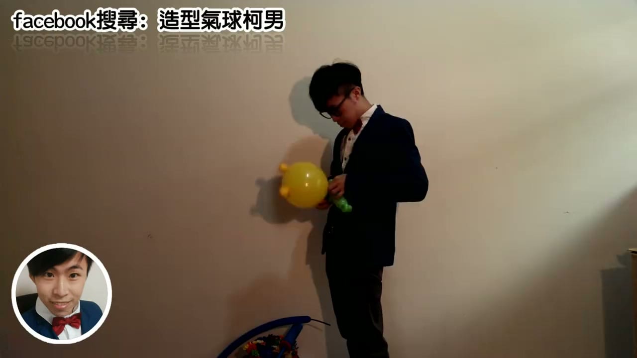 柯男吹黃色圓形氣球準備做巧虎的頭