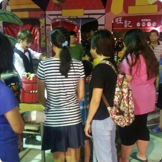 童話夜市彩色童話屋造型攤位旁，民眾排隊等折氣球