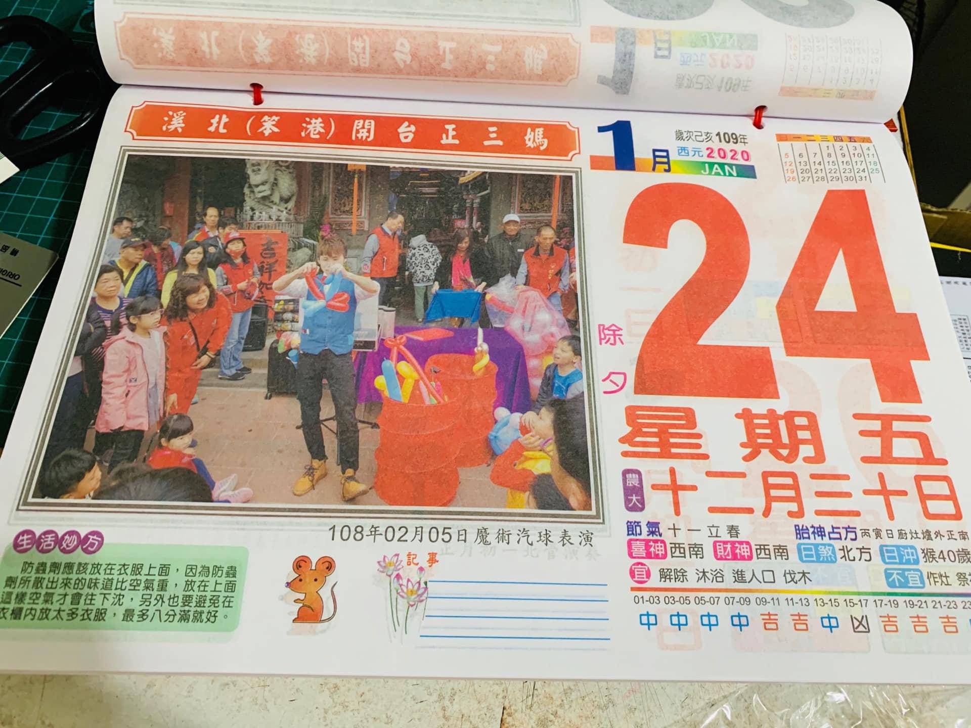 2020 年日曆除夕頁，印著六興宮廟前魔術汽球表演的照片
