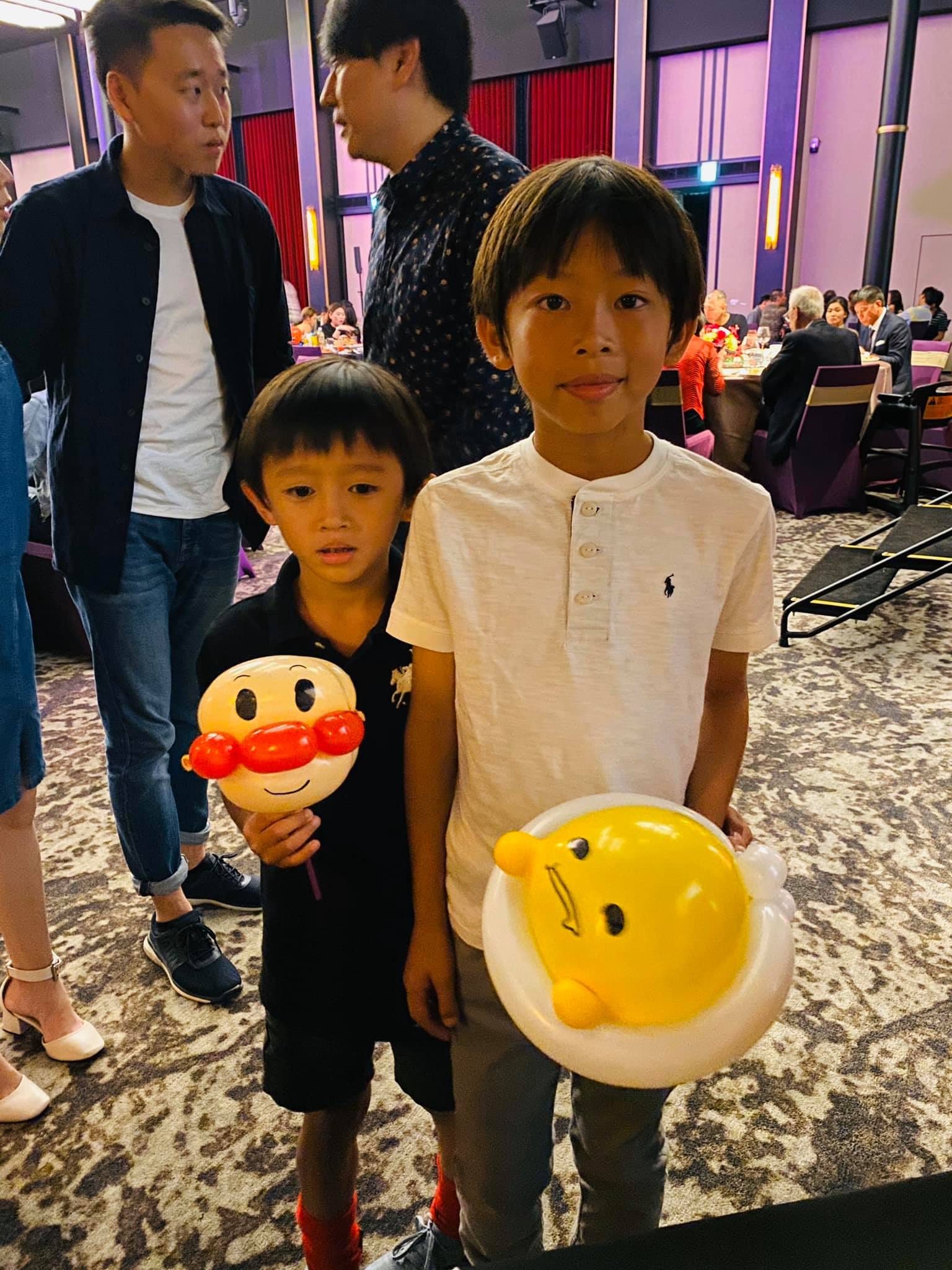 兩個男孩拿著麵包超人和蛋黃哥造型氣球，高雄婚宴會場