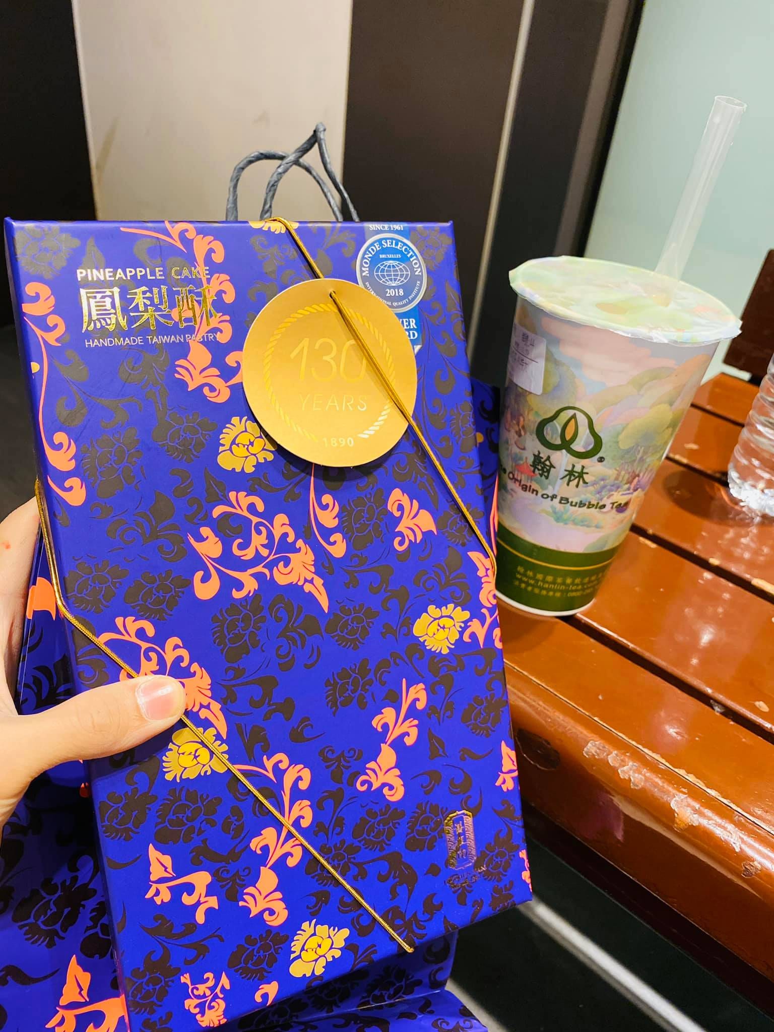 藍色花紋的鳳梨酥禮盒和一杯飲料