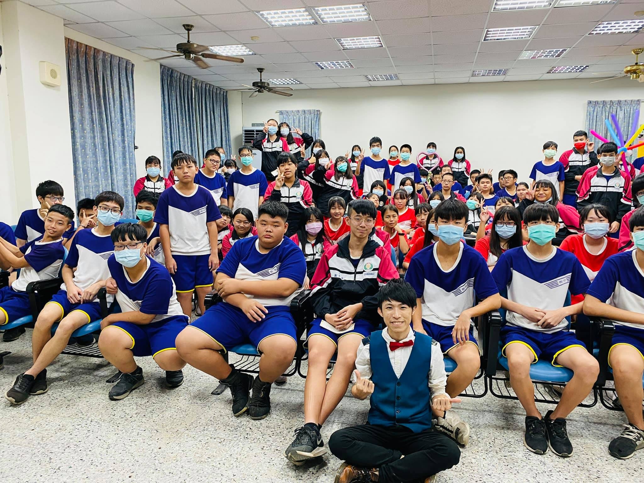 屏東高樹國中演講後，柯男盤腿坐在學生前方大合照