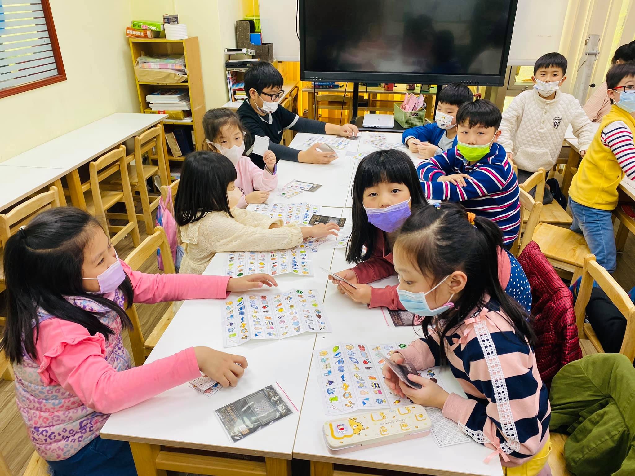教室裡的小朋友低頭專心練習手上的魔術道具