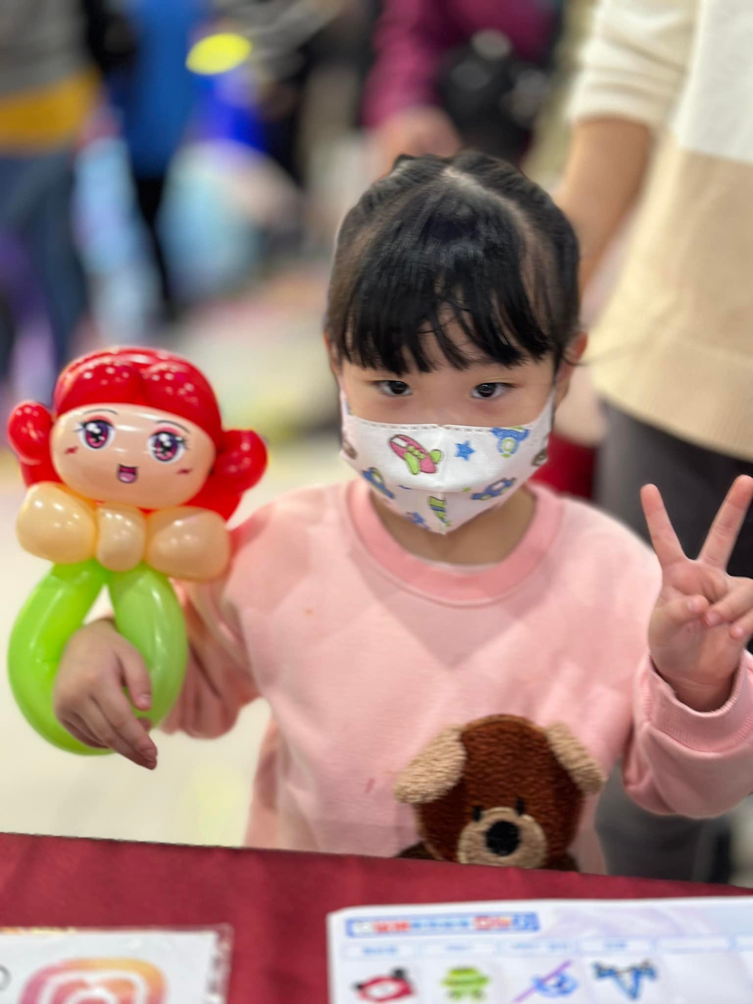 女孩比 YA，拿著紅髮綠尾巴的小美人魚造型氣球