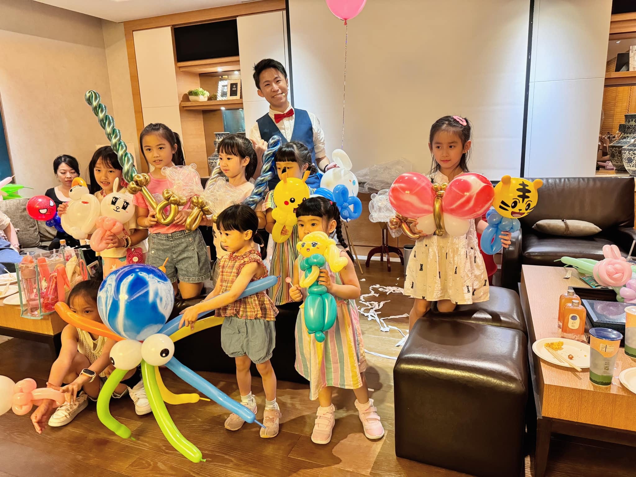 台北包廂聚會，孩子們拿著章魚、皮卡丘等氣球與柯男合照