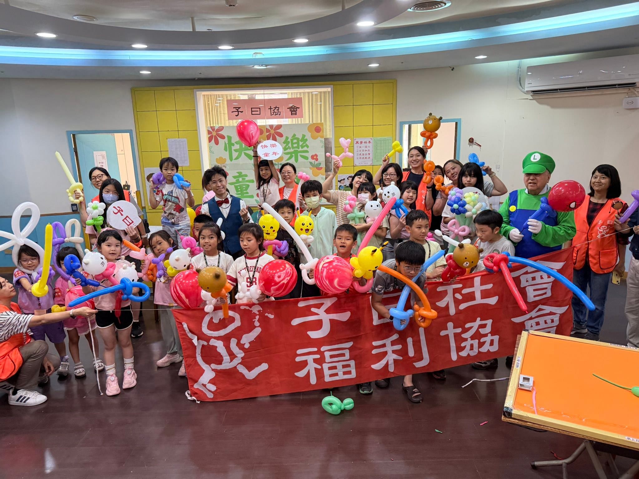 兒童氣球教學課結束後的大合照，孩子們舉著皮卡丘、Hello Kitty、寶劍與花朵造型氣球