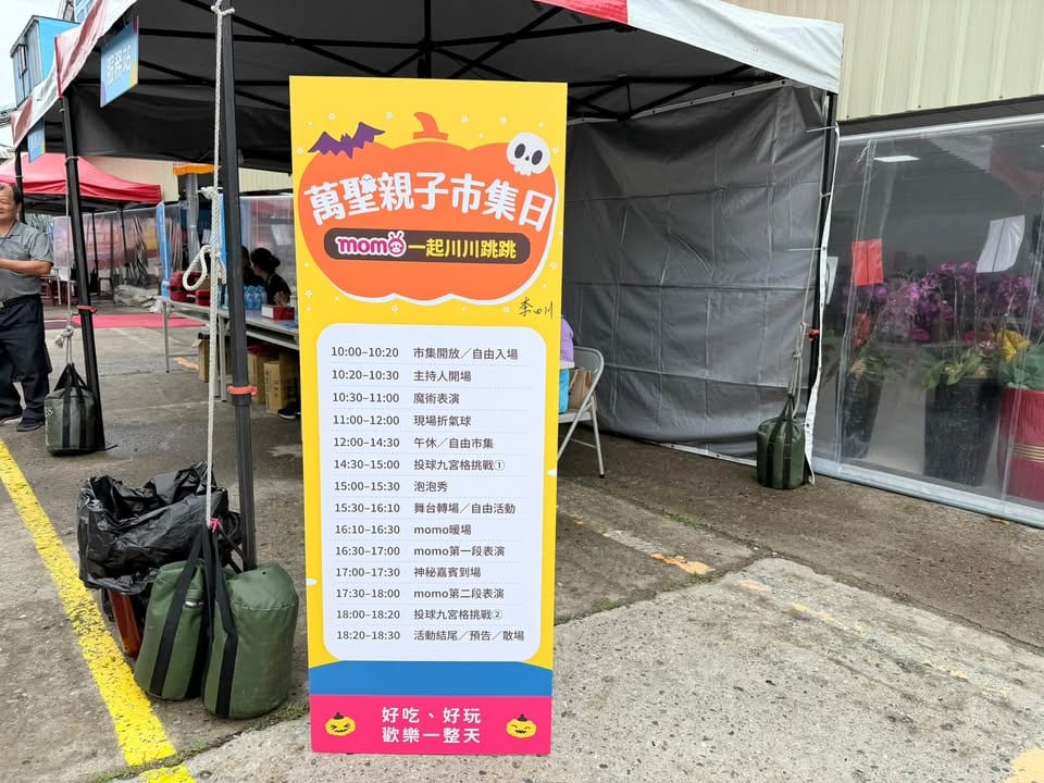 萬聖親子市集日的節目流程立牌，10:30 魔術表演、11:00 現場折氣球